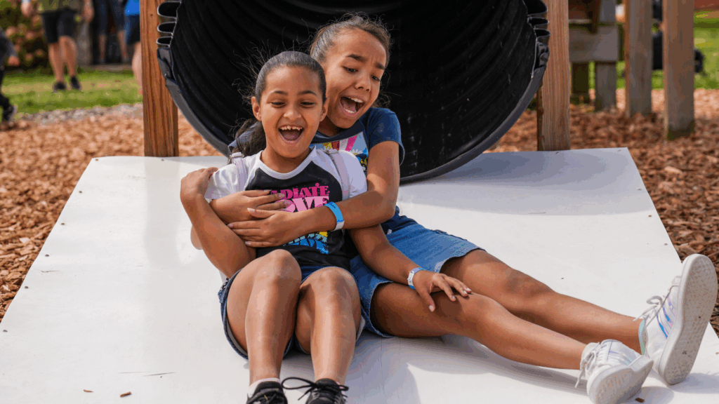 play yard girls on slide, summer fun on the farm, farm play yard